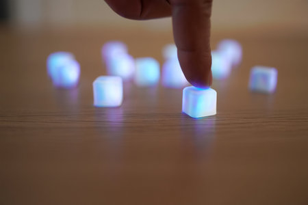 Finger pressing. Glowing blue cube. Creative technology concept. Light blur.の素材