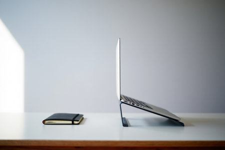 Laptop and notebook on desk. Minimalist design, studying space.の素材