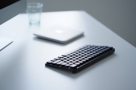 Minimalist workspace. Keyboard with accessories for productivity at table.の素材
