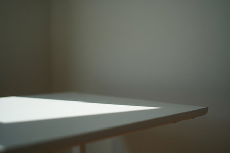 White table close-up, sunlight shadow. Abstract background with soft light.の素材