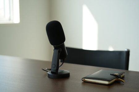 Podcast microphone on desk. Recording voice. Professional broadcasting studio.の素材