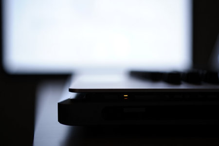 Laptop side view. Computer technology. Sleek design with screen.の素材