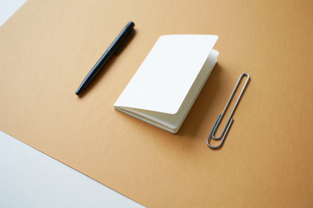 Blank white notebook with pen and clip. Minimalistic design and neutral tones. Notes and sketches.の素材