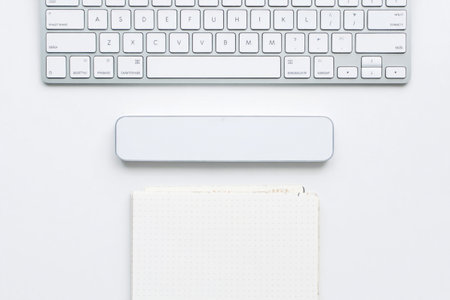 Workspace with keyboard, wrist rest, notebook. Clean organized home office.の素材