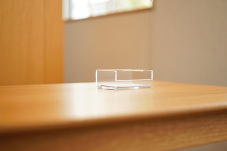 Acrylic box on table. Clear container for storage. Office supply.の素材