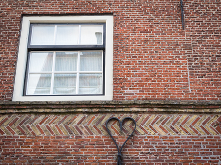 Iron work on an old house shaped like a heartの写真素材