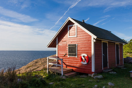 Red cottage at the coast near Oxelosund in south Swedenの写真素材
