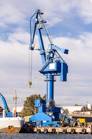 Blue crane unload cargo in a seaport in Swedenの写真素材