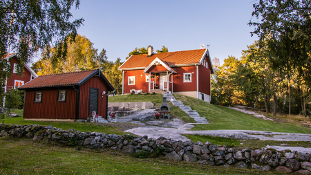 Red cottages on the island Harstena in Sweden, principally known for the seal hunting that was once carried out there. It is now a tourist attraction.の写真素材