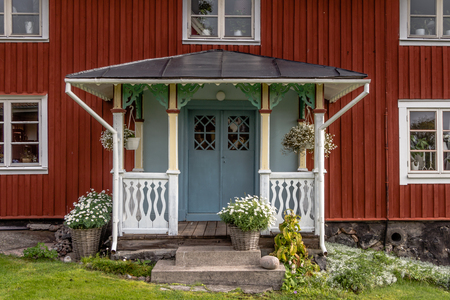 With flowers decorated facade Rof a ed cottage on the island Harstena in Swedenの写真素材