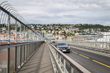 Walking over the bridge from the Arctic Cathedral to the center of Tromso in Norwayのeditorial素材
