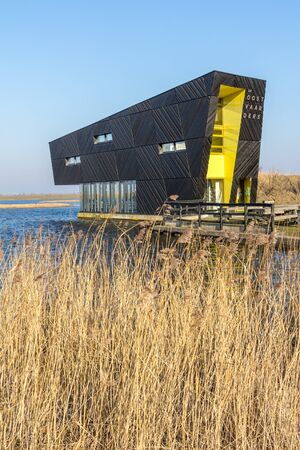 ALMERE, NETHERLANDS - MARCH 17, 2016: Visitor center Oostvaarders in NP Oostvaardersplassen, a large wild reserve with wetland and  large groups of konik horses and red deer.のeditorial素材
