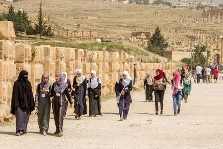 JERASH, JORDAN - APRIL 25, 2016:  Happy youn g woman on girl's day at the gate of Jerash (Jordan)のeditorial素材