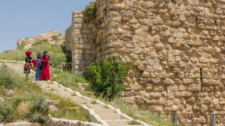 KARAK, JORDAN - APRIL 26, 2016: Three colorfull dressed young girls viewing the forstress of Karak in Jordanのeditorial素材