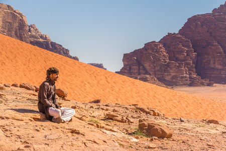 Wadi Rum, Jordan - April 30, 2016: Bedouin man is resting on a rock in Wadi Rum desert in Jordanのeditorial素材