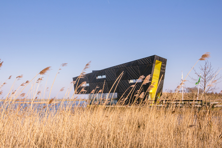ALMERE, NETHERLANDS - MARCH 17, 2016: Visitor center Oostvaarders in NP Oostvaardersplassen, a large wildlife reserve with wetland and large groups or konik horses and red deer.のeditorial素材