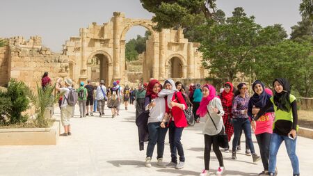 JERASH, JORDAN - APRIL 25, 2016:  Happy youn g woman on girl's day at the gate of Jerash (Jordan)のeditorial素材