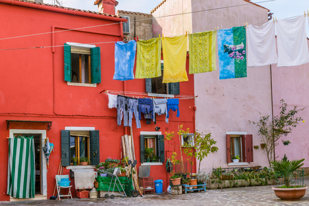 Venice, Italy - October 29, 2016: Multi-colored house and clothing line on the  island Burano, Venice, Italyのeditorial素材