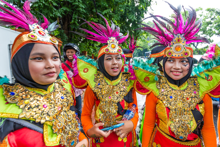 Jakarta, Indonesia - October, 10, 2017 Two smiling schoolgirls in colorful party clothes in Jakartaのeditorial素材