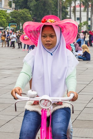 Jakarta, Indonesia - October, 28, 2017 Girl on a bike on Fatahillah Square, Kota Tua. old city of Batavia, Jakarta, Java Island, Indonesiaのeditorial素材