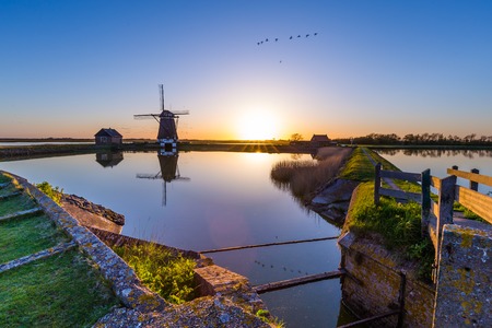 Dutch windmill Het Noorden during Sunset on the island Texel in the Netherlandsの写真素材