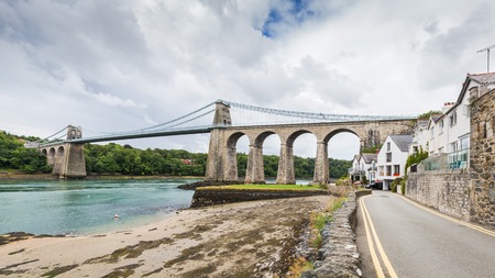 Menai Suspension Bridge between Anglesey and mainland of North Wales, UK. The bridge, opened in 1826, is known as the first modern suspension bridge in the world.の写真素材