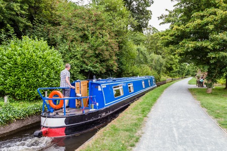 A canal boat on his way along the Llangollen canal near Llangollen in Wales, UKの写真素材