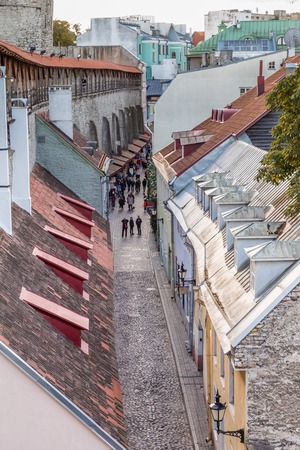 Tallinn, Estonia - September 29, 2018: Cityscape with the town wall of Talinn with a view on the cobbled street along the wall  in the old town of Tallinn in Estoniaのeditorial素材