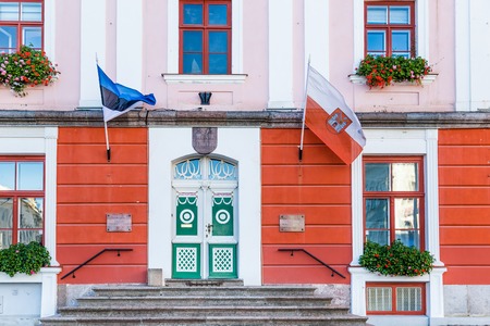 Tartu, Estonia - September 27, 2018: Entrance of the Town hall with the flags of Tartu and Estonia in the historical  centre of  Tartu in Estoniaのeditorial素材