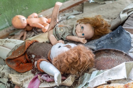 Dirty old dolls in an abandoned house in Chernobyl exclusion zone in Belarusの写真素材