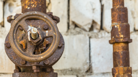 Old and rusty industrial pipe valve at power plantの写真素材