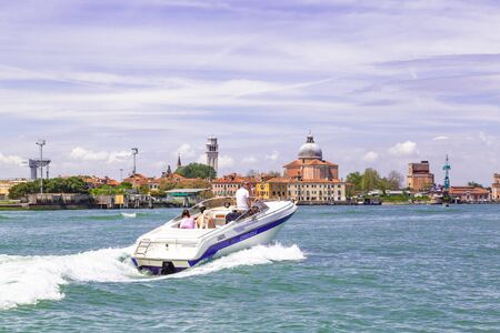 Venice Italy - May 25, 2019: Motor boat with family and dog crossing the Grand canal in Venice Italyのeditorial素材
