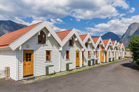 Beautiful traditional white wooden houses in Aurlandsvangen at the coast of Aurlandsfjord, branche of Sognefjord in Norwayの写真素材