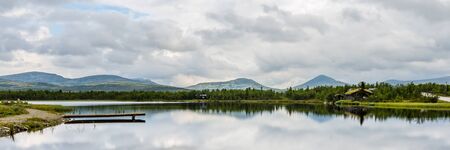 Panorama of Ringebu Kommune with view on a lake and the moutains of Rondane national Park in Oppland Norwayの写真素材