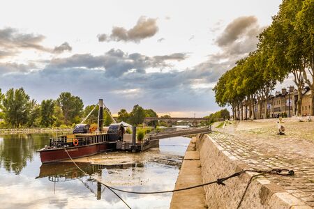Orleans, France, October 10, 2019: Paddle wheel boat on Orelans quay along the river Loire during the evening.のeditorial素材