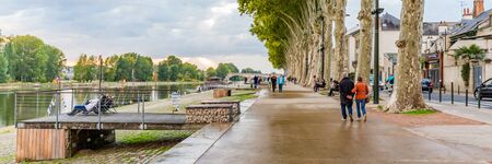 Orleans, France, October 10, 2019: Pedestrians walking on Orleans boulevard along the river Loire during sunsetのeditorial素材