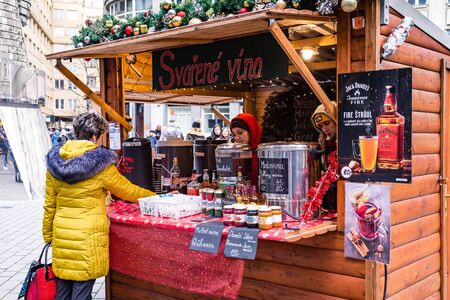 Prague,Czech Republic, December 12, 2019: Female preparing gluh wine and other hot drinks at Christmas market in the center of Pragueのeditorial素材