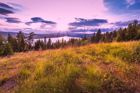 Sunset with view on Galavatnet lake and mountains in Gudbrandsdalen valley near Gala in Norway. Host...
