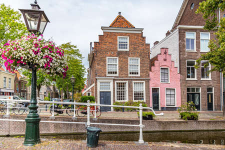 Cityscape Leiden street view with typical Dutch gable houses and canal in the old city centrer of Leiden in the Netherlandsの写真素材