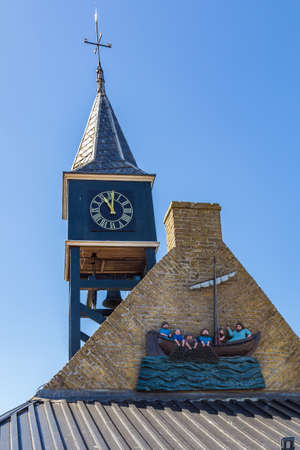Hindeloopen, Friesland, Netherlands - August 5, 2020: Clock tower in the picturesque fishing village Hindeloopen in Friesland in the Netherlandsのeditorial素材