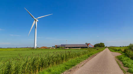Modern open farm with his own wind turbine in the Netherlands
