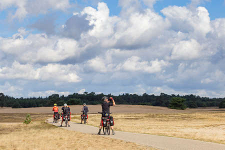 Ede, Netherlands - April 22 2020: Bikers enjoying the view in National Park De Hoge Veluwe,...