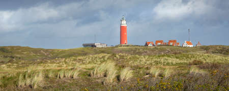 Panorama with scenic view of Lighthouse and rainy clouds at Waddenisland Texel, North Holland, Netherlandsの写真素材