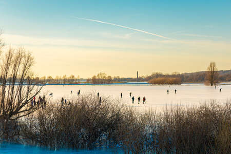 Ice skating on frozen floodplains in the Netherlandsの写真素材