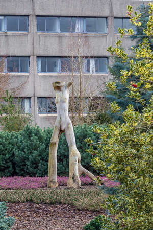 Female wooden art figure in apublic gardenのeditorial素材