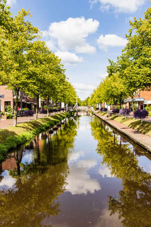 Papenburg, Germany - August 24, 2021: Colorful old village centre of Papenburg along river Ems with canals, little brdiges and ancient ships in Lower Saxony in Germanyのeditorial素材