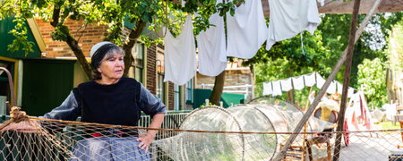 Enkhuizen, The Netherlands - July 7, 2021: Scenics with role players in traditional fishermans village in Enkhuizen North-Holland in The Netherlandsのeditorial素材