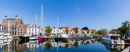 City port with colorful sailing ships in th ancient center of Goes in Zeeland in The Netherlands