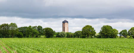 Landscape with agricultural land and water tower of Sint Jansklooster in Nationaal Park Weerribben-Wieden in Overijssel in The Netherlandsの写真素材