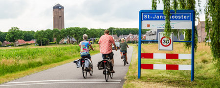 Sint Jansklooster- The Netherlands: June 20, 2021:Tourist passing entrance sign Sint Jansklooster National park Weerribben- Wieden in OVerijssel The Netherlandsのeditorial素材